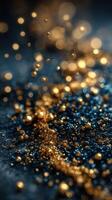 Sparkling gold and blue glitter creates a mesmerizing visual effect on a dark surface at night photo
