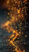 Sparkling golden particles create a mesmerizing cascade against a dark backdrop during an artistic display at night photo