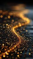 Golden droplets glisten along a dark surface reflecting light in a serene natural setting photo
