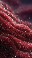 Sparkling red texture with glimmering particles captured in soft light on a reflective surface photo