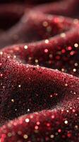 Textures of shimmering red fabric create an elegant display of sparkles and depth in a soft, flowing arrangement photo