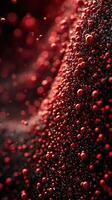 Close-up view of red droplets on a textured surface with soft lighting creating a dramatic effect photo