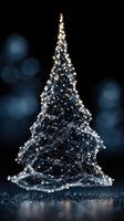 Illuminated wireframe Christmas tree shining in a darkened space with soft blue bokeh background photo