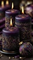 Elegant purple candles with intricate designs and warm flames creating a serene atmosphere during evening relaxation photo