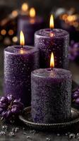 Elegant purple candles with glowing flames create a serene atmosphere during a cozy evening setting photo