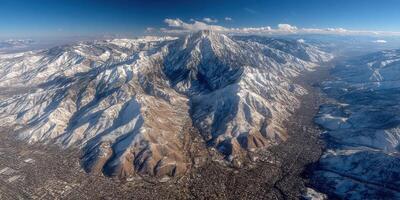 Mountain landscape near a city covered in snow with clear blue skies during daylight photo