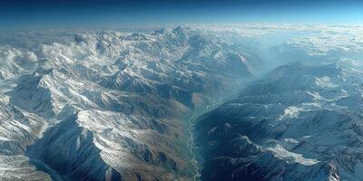 Majestic mountain range under cloudy sky with river flowing through valley at sunrise in the Himalayas photo