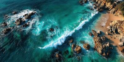 Waves crashing on rocky shore creating a beautiful coastal landscape in a sunlit seaside location photo