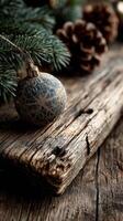 Decorative Christmas ornament on rustic wooden surface with pine branches and pine cones for festive atmosphere photo