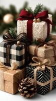 Festively wrapped holiday gifts stacked with natural decorations on a winter backdrop photo