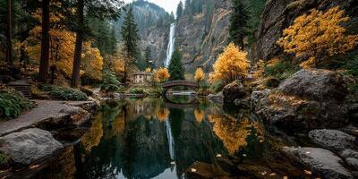 Stunning autumn view of waterfall cascading into lake surrounded by vibrant fall foliage and rocky landscape near a quaint cabin photo