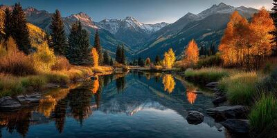 Mountain landscape reflecting in tranquil lake surrounded by autumn foliage at sunset photo