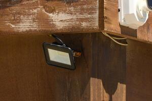 Bright outdoor light enhances rustic charm of wooden cabin during the warm afternoon sun photo