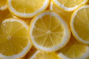 Bright slices of lemon arranged in a vibrant, refreshing pattern for culinary photo