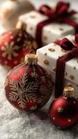 Beautiful red Christmas ornaments and neatly wrapped gifts on a snowy surface create a festive holiday atmosphere photo