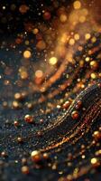 Sparkling golden particles flowing over a dark surface, creating a mesmerizing display of light and texture photo