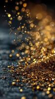Sparkling golden droplets dance in the air, creating a mesmerizing display of light and texture against a dark background photo