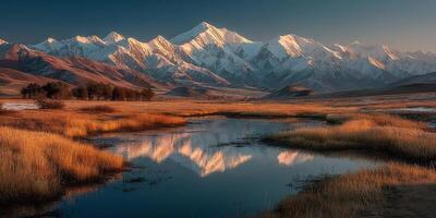 Majestic snow-capped mountains reflecting in a tranquil river at sunset under a clear sky photo