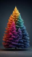 Vibrant multicolored coniferous trees arranged in a symmetrical pattern against a dark background photo