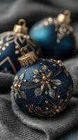 Elegant blue and gold ornaments arranged on a textured gray fabric for festive decoration during winter celebrations photo