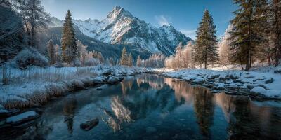 Majestic snowy landscape with mountains and a river in winter light during early morning photo