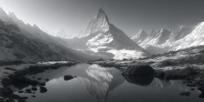 Majestic mountain peak reflecting in serene lake during crisp morning light in remote wilderness photo
