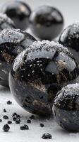 Black and silver spheres with a textured surface and sparkling details on a neutral background photo