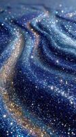 Sparkling blue and gold glitter forms a mesmerizing cosmic landscape resembling a starry night photo
