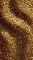Shimmering golden glitter creating a vibrant background texture with various reflective particles photo