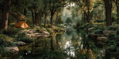 Sunny campsite by a serene river surrounded by lush trees in a peaceful forest setting during the late afternoon photo