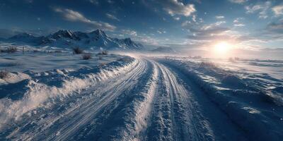 Snow-covered road winding through majestic mountains at sunset in a serene winter landscape photo