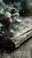 Snow-dusted pine branches and pine cones on weathered wooden surface in a winter setting photo