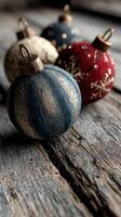 Beautifully crafted decorative Christmas ornaments in various colors against a rustic wooden background photo