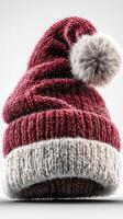 Cozy red winter hat with fur pom-pom on a neutral background perfect for holiday fashion and outdoor activities photo