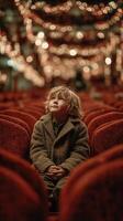 Child gazes in wonder at the glowing lights in a festive venue during evening celebration photo