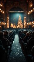 Audience enjoys holiday performance in ornate theater with illuminated Christmas tree in the background photo
