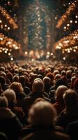 Crowd gathered in a grand theater during a nighttime performance with sparkling lights photo
