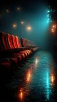 Chairs arranged in an empty theater creating a moody atmosphere with blue and orange lighting photo