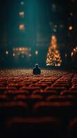 Empty theater filled with warm light and a solitary figure reflecting during the holiday season photo