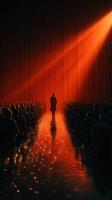 Audience captivated by speaker on stage illuminated by dramatic lighting during an evening event photo