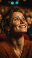 Excitement fills the air as a young woman enjoys a captivating performance in a crowded theater photo