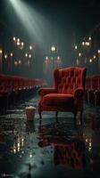Red velvet chair in an empty vintage theater with popcorn on the floor photo