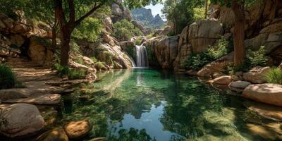 Majestic waterfall cascading into serene pool surrounded by rocks and lush greenery in a mountainous region photo