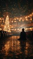 Reflections on a quiet evening with holiday lights and a tree illuminating a theater photo