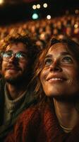 Couple enjoying a vibrant event with smiles and admiration in a crowded venue during an evening performance photo