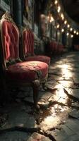 Old upholstered chairs in a dimly lit corridor with cracked floor reflecting soft light at dusk photo