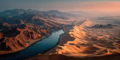 Expansive desert landscape with river winding through sandy dunes at sunset photo