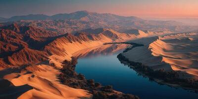 Stunning sunset over a tranquil river framed by golden sand dunes in a remote desert landscape photo