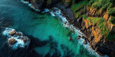 Coastal cliffs meet turquoise waters at a rugged shoreline during golden hour photo