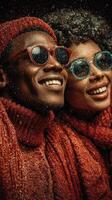 Couple enjoys a cozy winter moment with joyful smiles and colorful sunglasses while surrounded by falling snowflakes photo